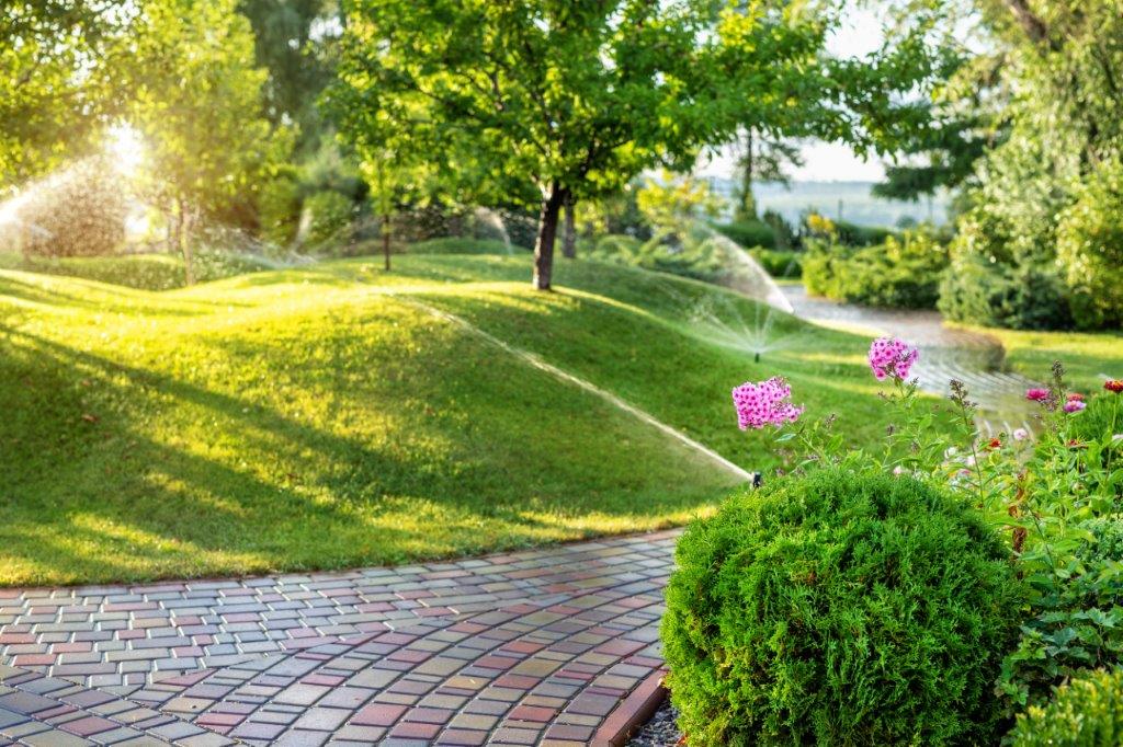 a well-kept park being watered by an irrigation system